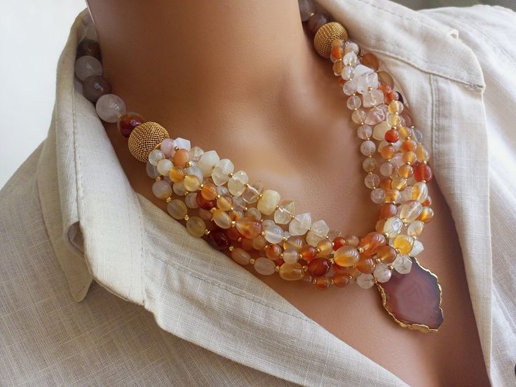 Meet our elegant Quartz - Agate Beaded Necklace, a collection of unique handcrafted jewelry that is sure to attract attention! This eye-catching necklace creates a striking visual with large gem stones in different shades of orange. Perfect as a gift for a beloved mother or wife, this statement chunky multi-strand natural stone summer accessory will add a bohemian touch to any outfit. CARE INSTRUCTIONS: To keep your necklace looking its best, avoid exposing it to harsh chemicals or excessive moi Unique Handcrafted Jewelry, Orange Agate, Jewellery Inspiration, Necklace Chunky, Mineral Stone, Gem Stones, Crystal Quartz, Jewelry Inspo, Summer Accessories