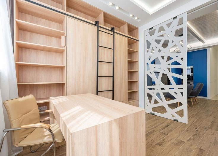 an office with wooden shelves and chairs in the center, next to a blue wall