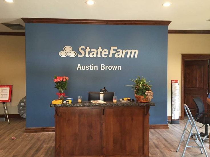 the state farm office is located in an empty room with blue walls and wood floors