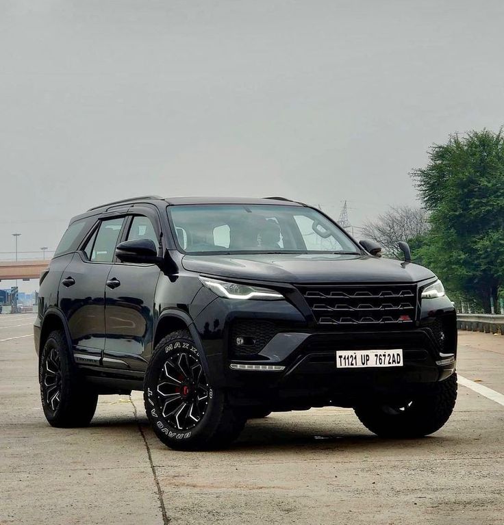 a black suv is parked in the parking lot