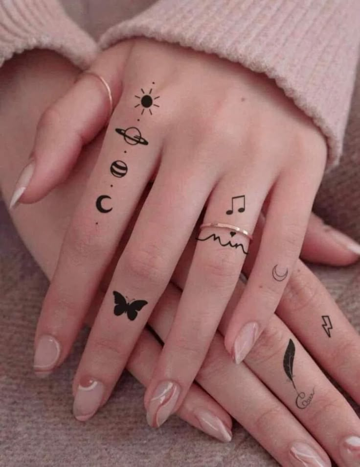 two hands with different tattoos on them and one has a butterfly, the other has music notes