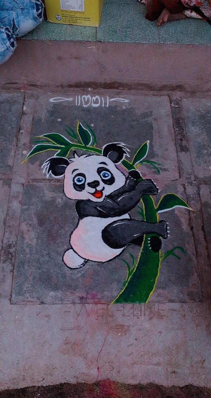 a panda bear is painted on the sidewalk