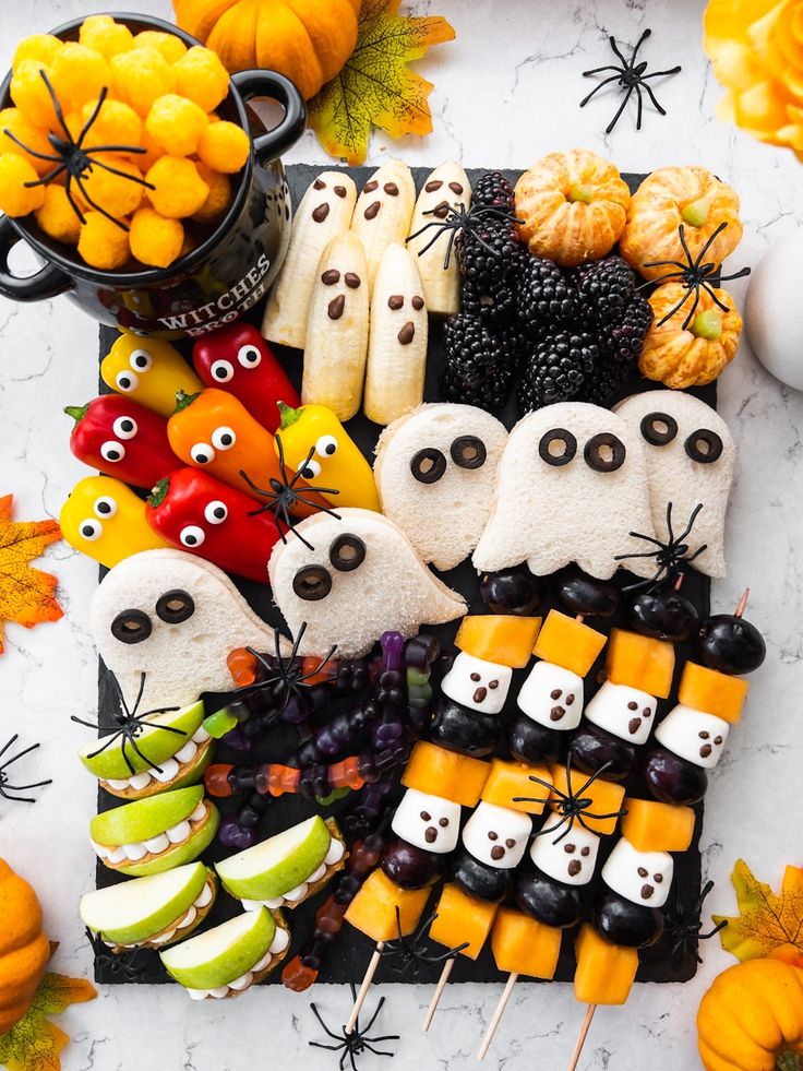 a table topped with lots of halloween treats