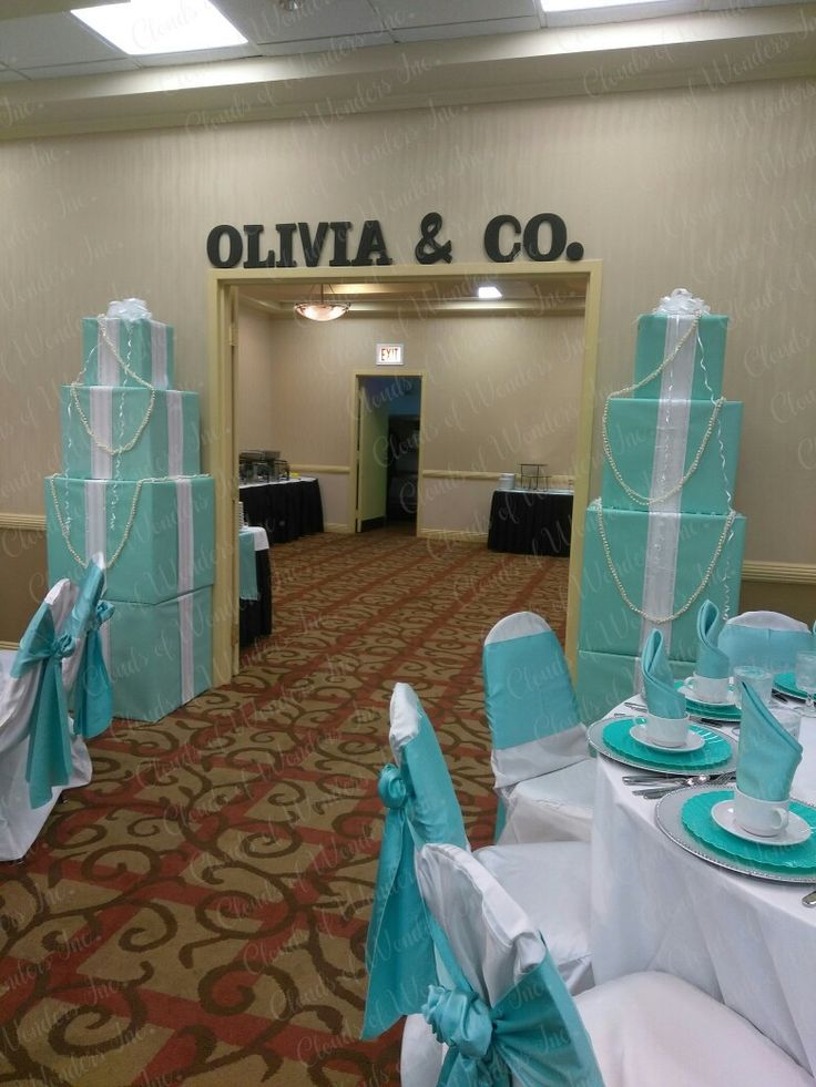 tables and chairs are set up in the hallway for a wedding or special event with blue bows on them