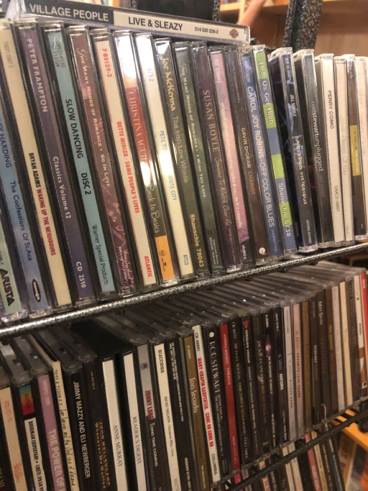 a rack full of various cd's in a store