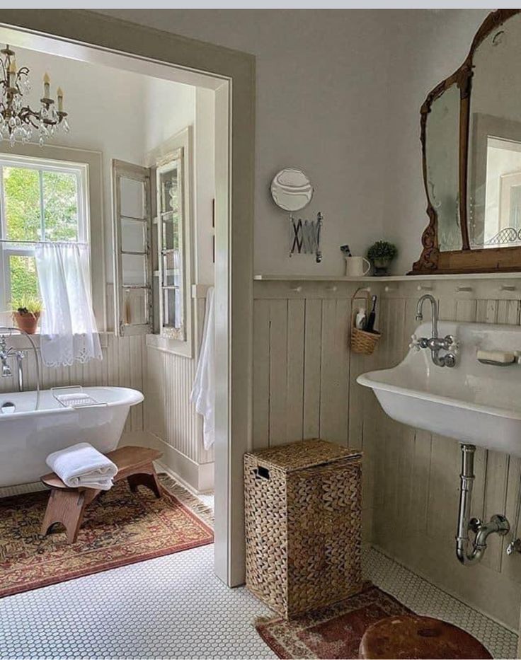 a bathroom with a tub, sink and mirror next to a window in the wall