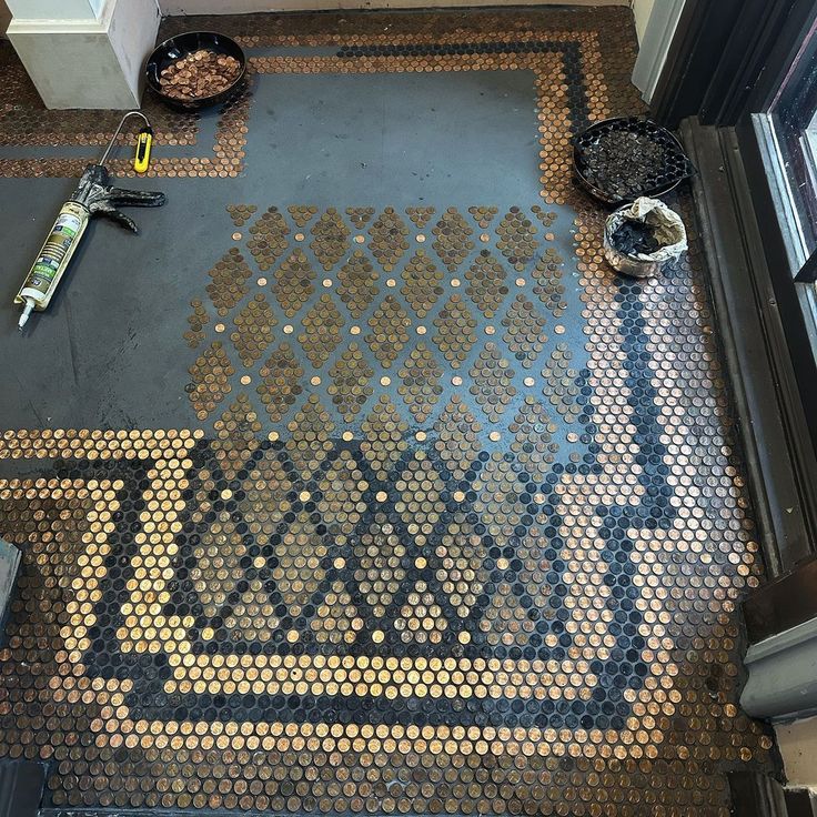 the floor is made out of coins and has a mosaic design on it, along with other items