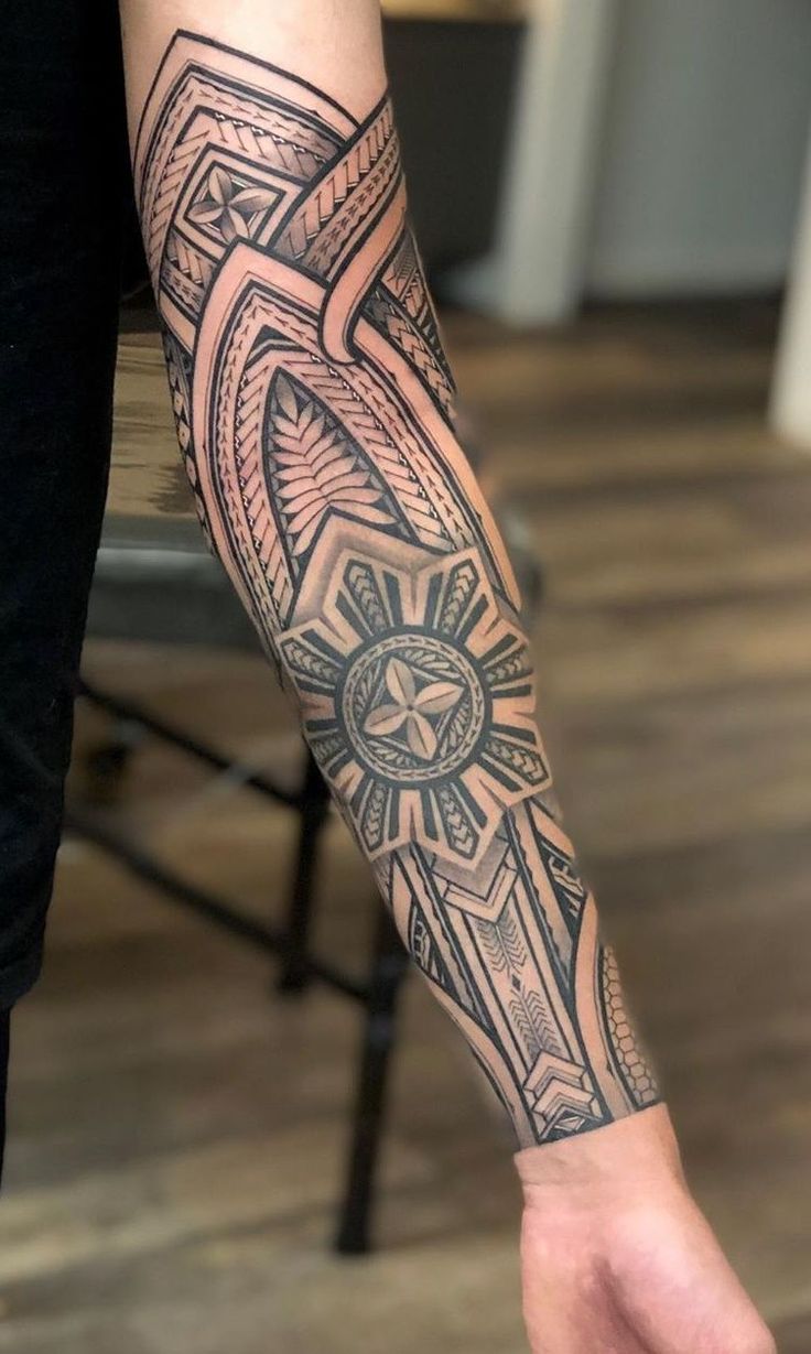 a man's arm with a cross tattoo on it and an eagle in the center