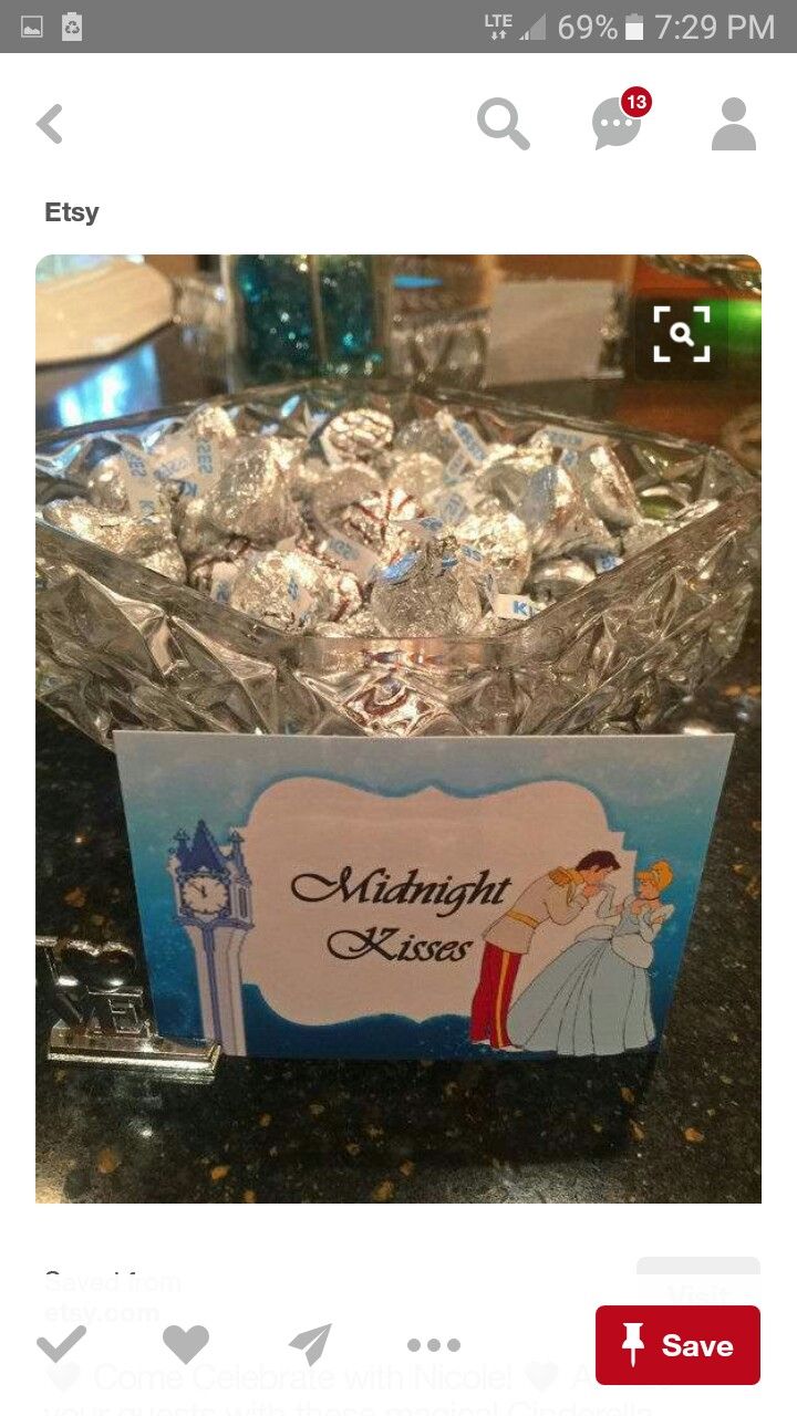 a glass bowl filled with silver foil on top of a black counter next to a sign that says midnight kisses