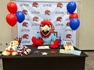 a table with balloons and stuffed animals on it