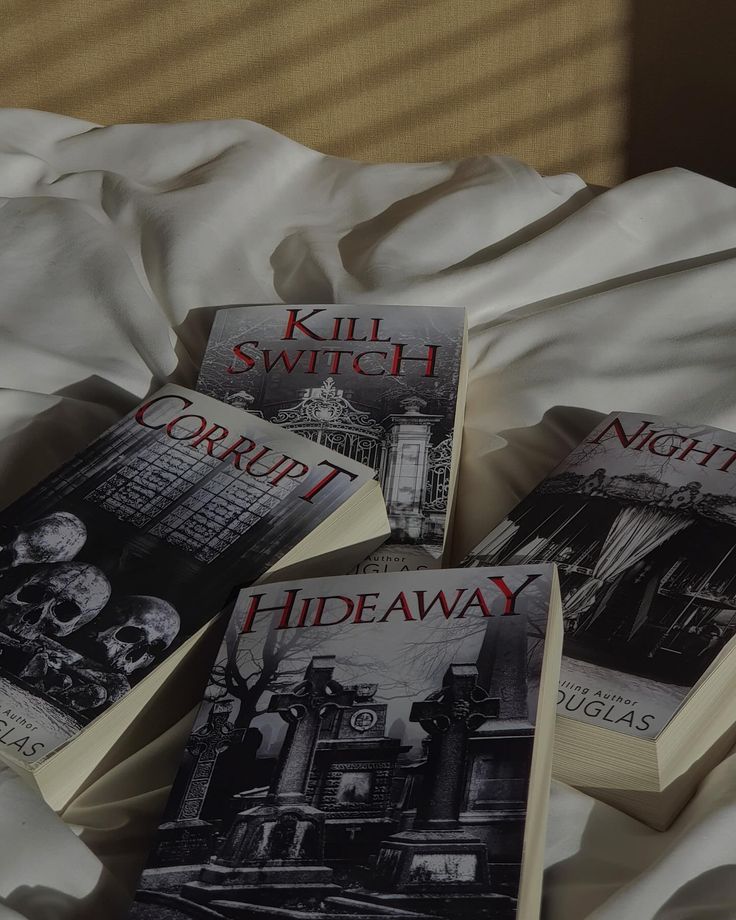 three books laying on top of a bed next to each other