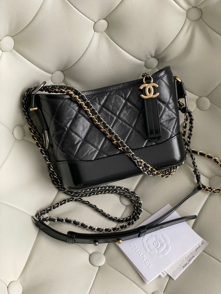 Chanel Gabriel Hobo small in black calfskin leather matelassè with a dual colour iconic chain. The bag is in pristine condition.Comes with the whole storage set. Hologram: 28xxxxxx Year: 2019 Measurements: 21 x 16 x 9 cm Chanel Bag Gabriel, Chanel Leather Bag, Chanel Bag 2024, Chanel Gabrielle Bag Outfit, Gabriel Chanel, Chanel Hobo Bag, Chanel Gabrielle Bag, Designer Crossbody Bag, Multi Colored Bag