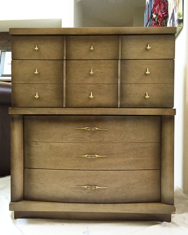 a wooden dresser sitting on top of a white floor