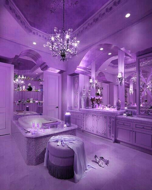 a purple bathroom with chandelier, tub and lights on the ceiling is lit up