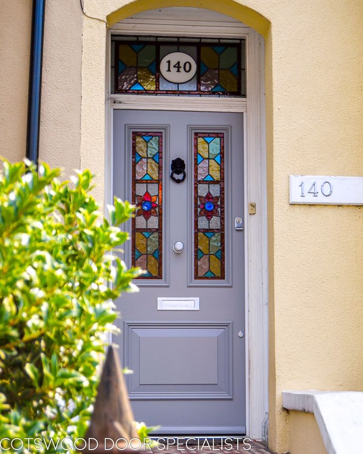 a grey door with stained glass on it