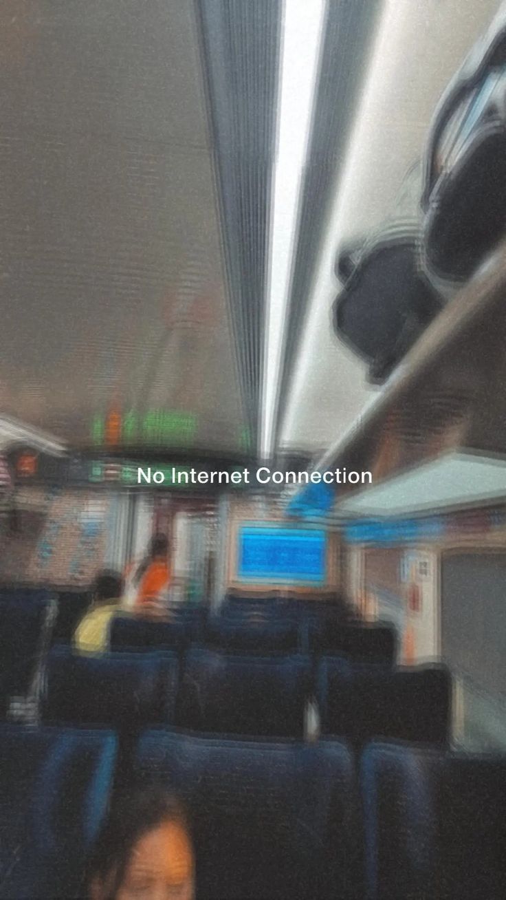 a blurry photo of people sitting in seats on an airplane with the words no internet connection above them