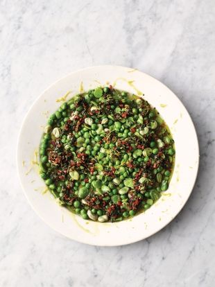 a white bowl filled with green peas and seasoning