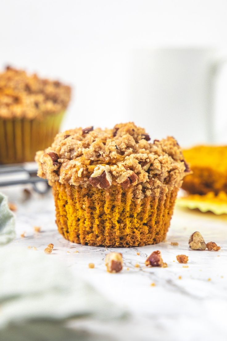 two muffins sitting on top of a white table