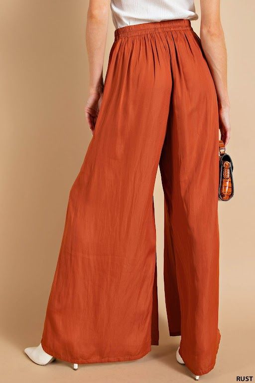 Description Add a touch of elegance (and comfort) to your wardrobe with our Blushing Satin Pants. Featuring a light weight, flowy fit and an elastic waistband, these pants are perfect for any occasion. And with convenient side pockets, you'll never have to leave anything behind. Rust never looked so good!" Specs Self: 100% Polyester Unlined Hand wash cold Do Not Bleach Hang dry Fits true to size - model is wearing a small S (0-4), M (6-8), L (10-12) SKU#: IS-003360 Please note that all online inventory reflects inventory in store. Chic Summer Pull-on Style Pants, Trendy Full Length Pants For Vacation, Trendy Full-length Pants For Vacation, Trendy Pants For Vacation, Versatile Full Length Wide Leg Pants For Vacation, Wide Leg Parachute Pants With Pockets For Vacation, Full Length Rayon Pants For Loungewear, Summer Straight Rayon Pants, Solid Rayon Beach Bottoms