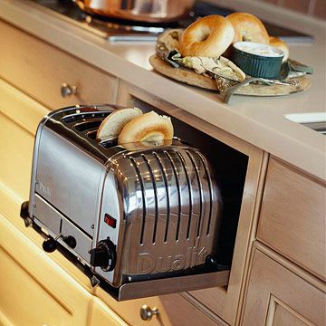 a toaster with some bagels in it sitting on a counter next to an oven