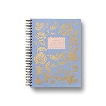 a blue notebook with gold foil flowers on it