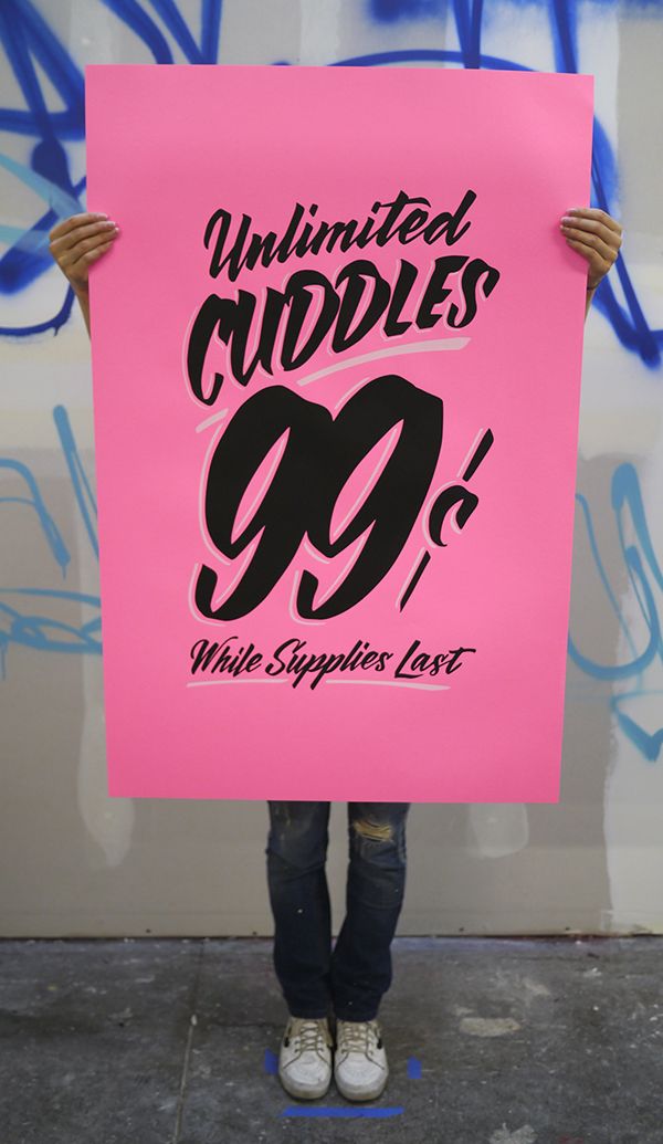 a person holding up a pink sign with the words ultimate cuddles 90 % written on it