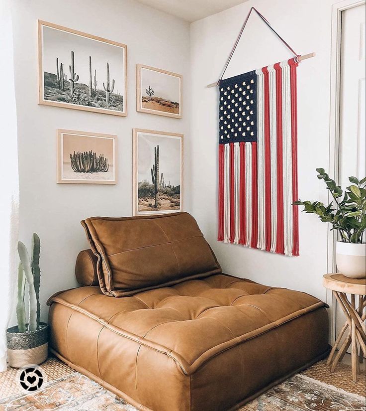 a living room with an american flag hanging on the wall and a leather chaise lounge