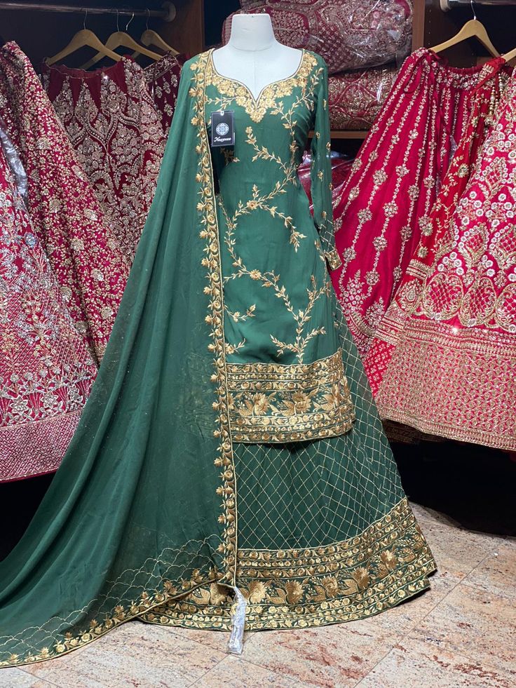 Pine green intricate with gold thread and zari embroidery all over the top with long sleeves. Complimented with matching color embroidered Skirt and georgette dupatta. Fabric: Georgette Size: 38 Ready to Ship! Green Dola Silk Sharara With Intricate Embroidery, Green Unstitched Lehenga With Intricate Embroidery, Unstitched Green Lehenga With Intricate Embroidery, Green Anarkali Set With Intricate Embroidery For Eid, Eid Green Anarkali Set With Intricate Embroidery, Eid Anarkali Set With Intricate Embroidery In Green, Green Floor-length Dola Silk Traditional Wear, Green Art Silk Anarkali Set With Intricate Embroidery, Green Art Silk Sets With Intricate Embroidery