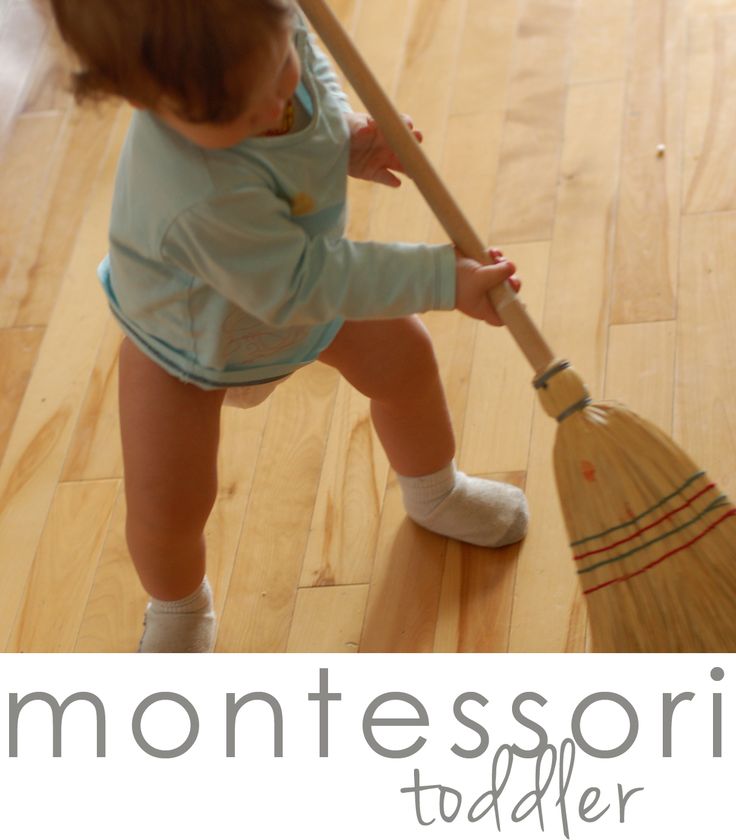 a toddler holding a broom on the floor with words montessori together above it