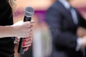 a woman holding a microphone in her hand