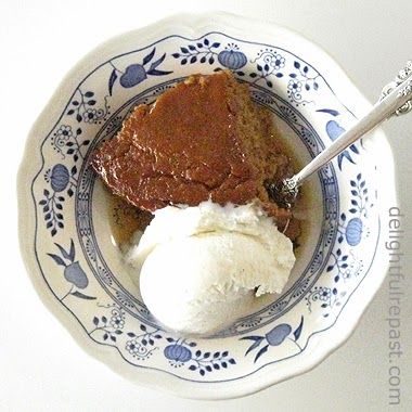 a bowl filled with ice cream and some kind of dessert on top of a blue and white plate