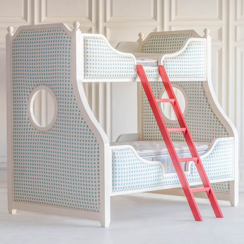 a white and blue bed with a red ladder on the bottom bunk next to it