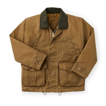 Our Tin Cloth Field Jacket is a proven classic that’s earned its keep with rugged durability and multi-use versatility in the field and on the job. Built with our signature oil finish Tin Cloth that turns away rain, snow, thorns and abrasion like no other fabric can. The shoulders of this field jacket are a one-piece design that eliminates seams for maximum water resistance. The collar and high-set hand pockets are both lined with Mackinaw Wool for maximum warmth even in the wettest conditions. Field Jacket Men, One Piece D, Filson Jacket, Field Work, Best Winter Coats, Work Chic, Mens Winter Coat, Pet Bird, Dark Tan