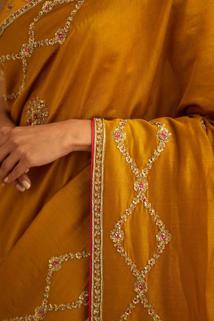 Editor's Note A mustard yellow zardozi embroidered dupion silk sari and blouse would be a stunning choice for a traditional event or wedding. The rich and vibrant color paired with intricate zardozi embroidery would make for a gorgeous and elegant ensemble. Color: Mustard yellow Fabric: Dupion silk & chanderi Embroidery details: Zardozi embroidery Components: Sari & blouse Sari length: 6 meters, sari width: 46" inches Occasion: Festive and Wedding Guest Disclaimer: Product color may slightly var Embroidery On Yellow Fabric, Zardozi Embroidery Designs, Mustard Yellow Outfit, Mustard Yellow Blouse, Bridal Hairstyle Indian Wedding, Blouse Sari, Saree Work, Embellishment Ideas, Zardozi Embroidery