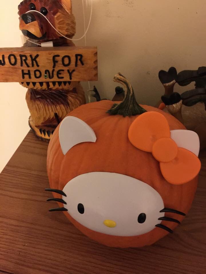 a hello kitty pumpkin sitting on top of a wooden table