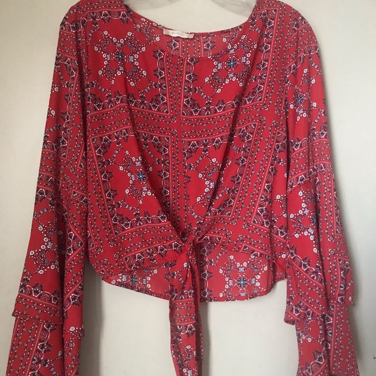 Altar’d State Women’s Red Layered Bell Sleeve Round Neck Floral Crop Tie Front Blouse Size L 100% Polyester Chic Red Printed Blouse, Red Long Sleeve Blouse For Vacation, Red Long Sleeve Beach Blouse, Chic Red Printed Tops, Red Long Sleeve Blouse For Day Out, Flowy Red Blouse For Vacation, Chic Flowy Red Blouse, Chic Red Flowy Blouse, Red Printed Tops For Day Out