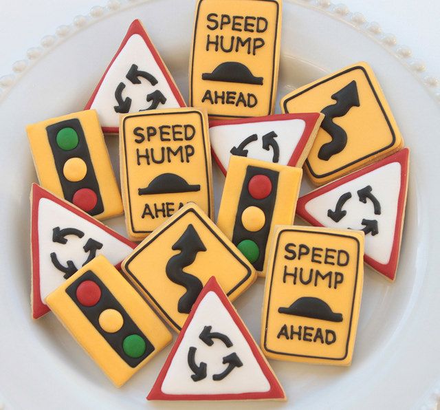 decorated cookies are on a plate with traffic signs