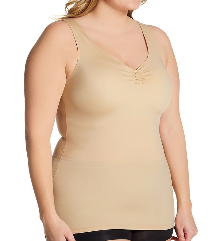 This sleek tank top slips on like an undershirt to provide you with a smoother, more sculpted figure in a matter of seconds. Made of nylon and spandex. Plunging, V-shaped neckline has covered elastic edge to keep fit close and in place. Base of neckline has non-stretch vertical ruching that allows fit to expand over the bust, with separation for a more natural look. Side seams curve inward for waist shaping. Firms and flattens the waist and tummy, helping prevent muffin top. Sleeveless arm openi Solid Full Coverage Shapewear Tank Top, Shaping Tops For Summer, Summer Shaping Solid Tops, Supportive Seamless Sleeveless Shapewear, Seamless Supportive Sleeveless Shapewear, Shaping Scoop Neck Camisole Shapewear, Supportive Shapewear Tank Top With Medium Bust Support, Shaping Scoop Neck Shapewear Camisole, Solid Color Shaping Camisole With Smoothing Details