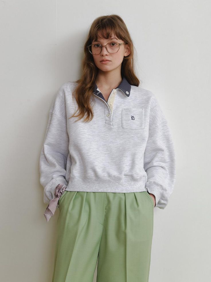 This product is the Hackney Sweatshirt, which offers a relaxed and stylish look with its half-buttoned collar and kangaroo pocket. The design is both casual and functional, making it a comfortable choice for everyday wear. The soft fabric ensures warmth and coziness, while the sweatshirt's silhouette provides a modern touch to a classic piece. - The half-buttoned collar gives a nod to traditional polo styles but with a laid-back sweatshirt twist.- A kangaroo pocket at the front adds practic Casual Spring Polo Sweater, Oversized Casual Polo Sweater For Spring, Casual Half-zip Top With Kangaroo Pocket, Oversized Casual Polo Sweater For Work, Casual Oversized Polo Sweater For Work, Relaxed Fit Collared Sweatshirt, Collared Cotton Sweatshirt, Casual Half-zip Sweatshirt With Pockets, Half-zip Loungewear Tops With Pockets