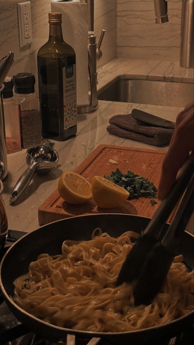 a pan filled with noodles and sauce on top of a kitchen counter