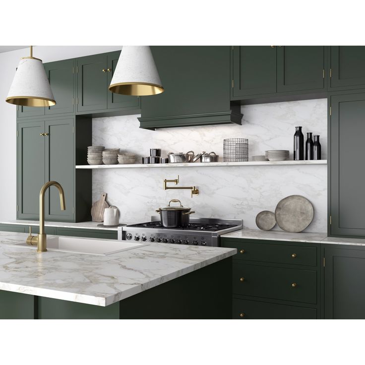 a kitchen with green cabinets and marble counter tops, two pendant lights above the sink