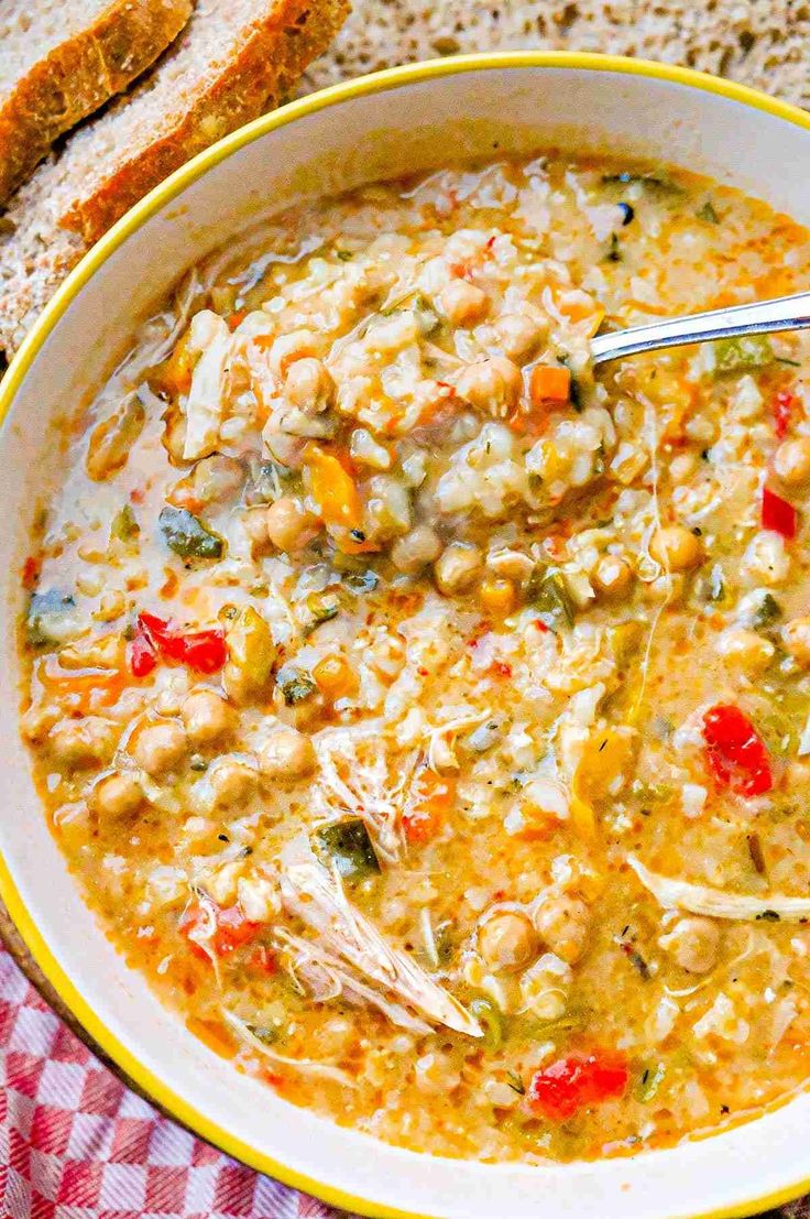 a bowl of soup with bread on the side