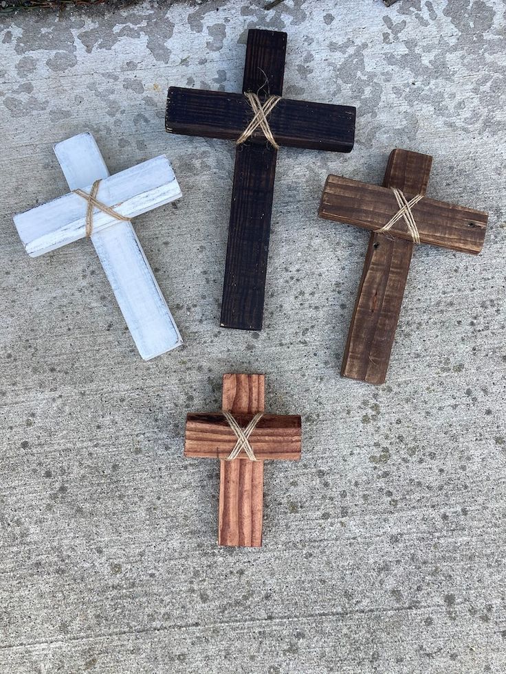 four wooden crosses laid out on the ground