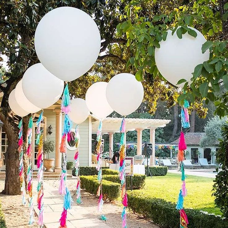 balloons and streamers are hanging from the trees