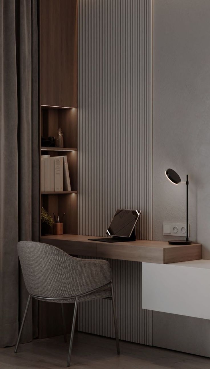 a desk with a chair, lamp and bookshelf in the corner next to it