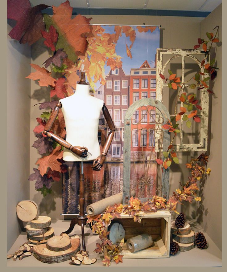 a display case filled with lots of different types of fall leaves and other things on top of a table