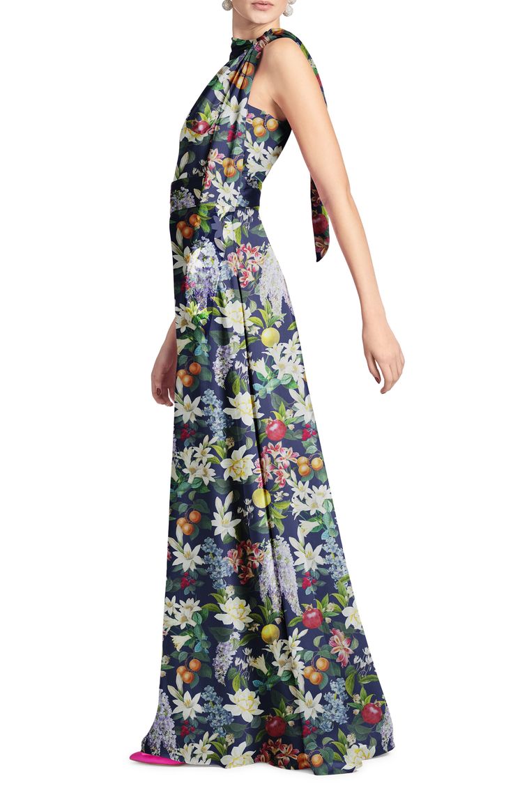 a woman in a long dress with flowers on it