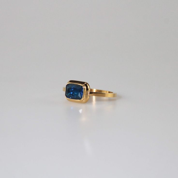 Square Royal Blue Stone Ring Modern Gold Topaz Ring In Rectangular Shape, Modern Gold Rectangular Topaz Ring, Luxury Blue Square Cut Ring, Modern Blue Radiant Cut Rings, Timeless Blue Radiant Cut Sapphire Ring, Blue Square Cut Topaz Ring, Modern Blue Sapphire Ring In 14k Gold, Blue Square Cut Topaz Ring Gift, Gift Blue Square Cut Topaz Ring