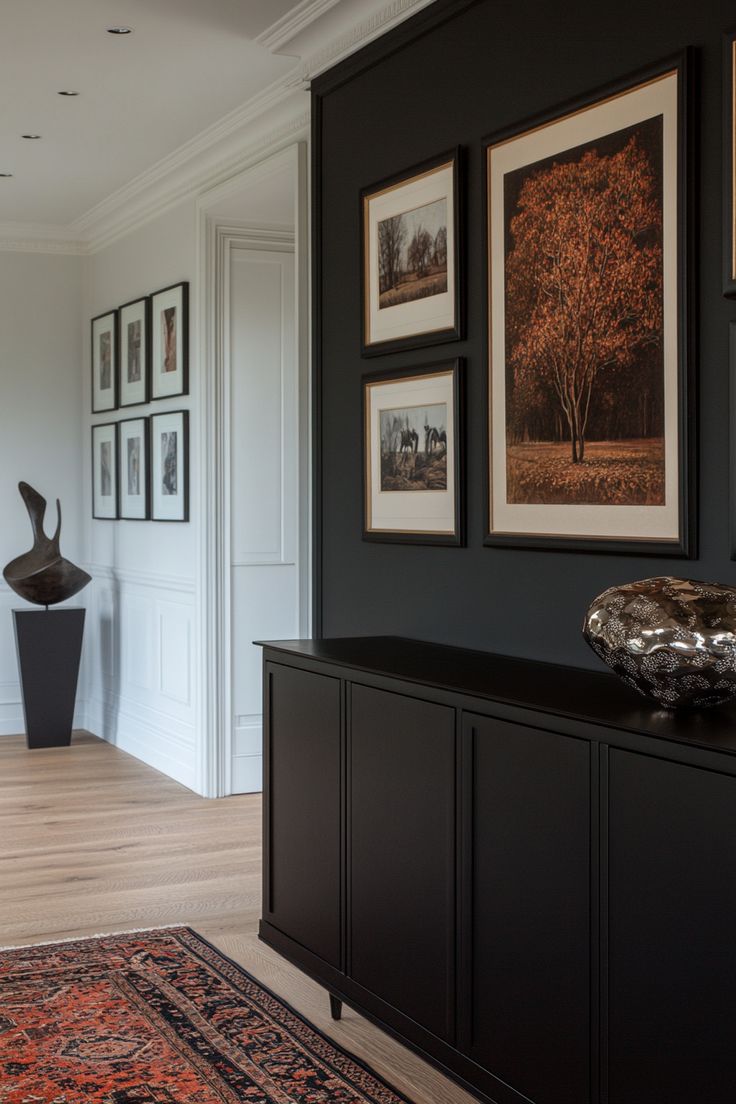 a living room with pictures on the wall and an area rug in front of it