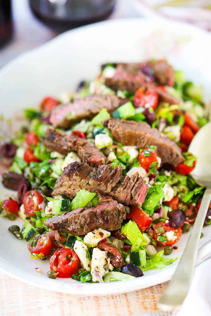 greek salad with grilled steak and vegetables